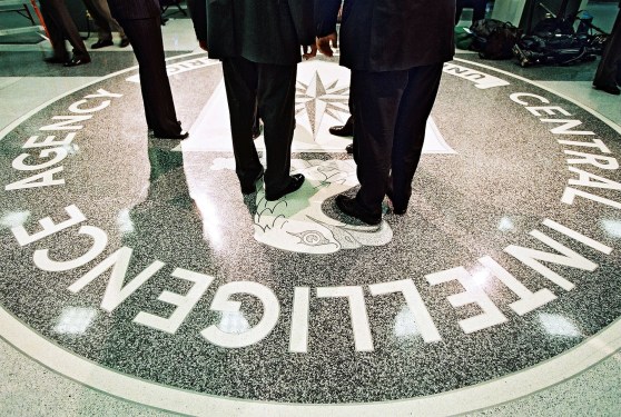 386984 06: President George W. Bush, Central Intelligence Agency Director George Tenet and others stand on the seal of the Agency March 20, 2001 at the CIA Headquarters in Langley, Virginia. Bush toured the facility and met some of the Agency''s employees. (Pool Photo by David Burnett/Newsmakers)