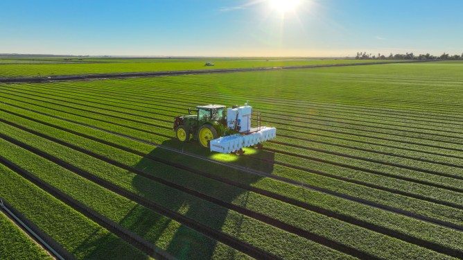 Carbon Robotics' LaserWeeder machine operating a in a field.