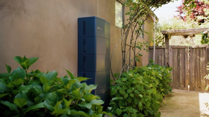 A stationary battery is attached to a home.
